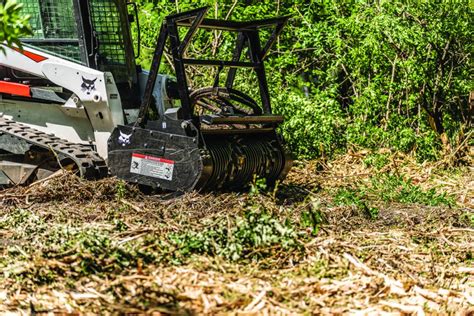 clearing brush with skid steer bucket|bobcat attachments for clearing brush.